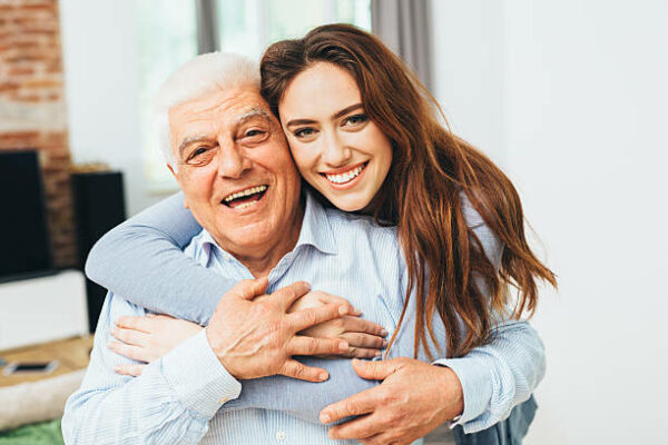 Beautiful woman with her father as they both smile